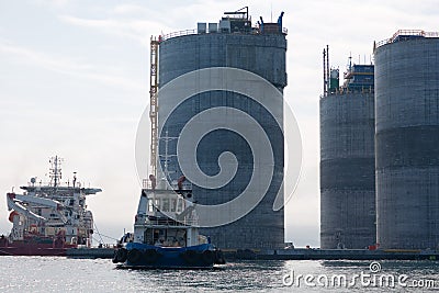 Base of oil platform and tugs Stock Photo