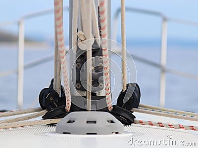 The base for securing the mainsail on the deck of a cruise yacht. Folding carriages and ropes for raising sails. Bermuda sloop equ Stock Photo