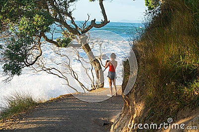 Base track popular walk with people walking caught in suns raysoff sea Editorial Stock Photo