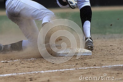 Baseball Action Image - Feet first slide into base Editorial Stock Photo