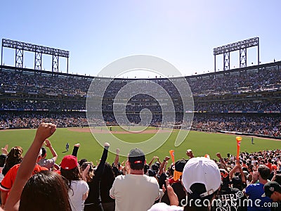 Baseball Fans in the bleachers put hands in the air as the cheer during game Editorial Stock Photo