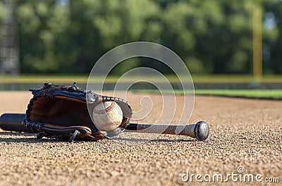 Baseball in a mitt with a black bat low angle selective focus view on a baseball field Stock Photo