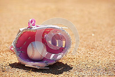 Baseball in Pink Glove on Field Stock Photo