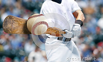 Baseball player hitting ball with bat in close up Stock Photo