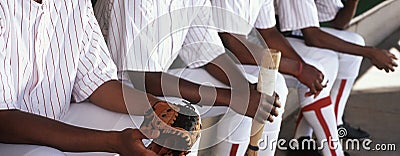 Baseball Players Sitting Together In Dugout Stock Photo