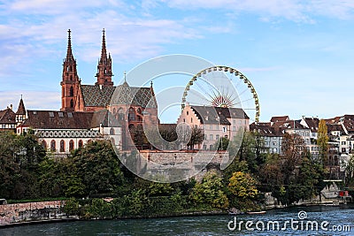 Basel Munster church in the river Rhine with the big ferris wheel Stock Photo