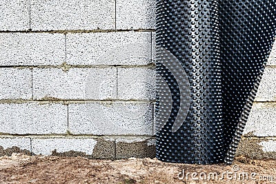 Basement wall waterproofing - installing dimple geomembrane Stock Photo
