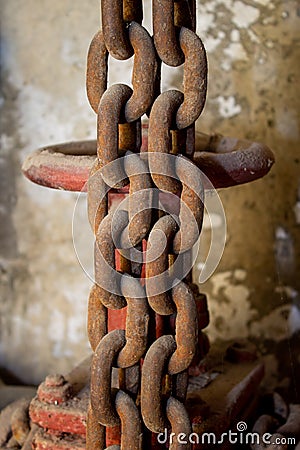 Basement, water valve, Old rusty chains hang on the background Stock Photo