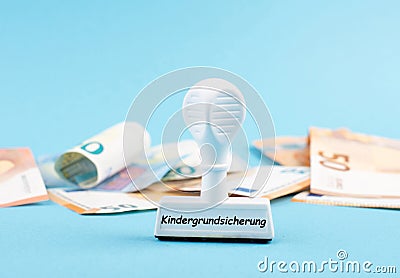 Basic child benefit stands in german language on the stamp, Euro banknotes in the background, new regulation Stock Photo