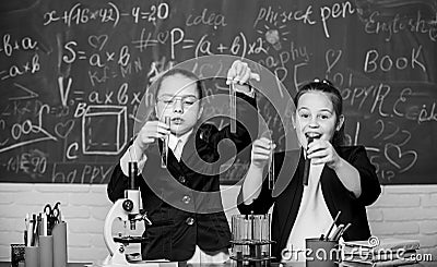 Basic knowledge of chemistry. Girls study chemistry. Make studying chemistry interesting. Microscope and test tubes on Stock Photo
