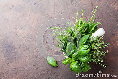 Basil, thyme, rosemary and tarragon. Mortar bowl with fresh aromatic herbs for cooking from above. Stock Photo