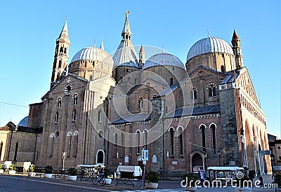 Basilica del Santo in Padua. Illuminated by the sun near sunset with the spiers, the bell tower and the domes, immersed in the blu Editorial Stock Photo