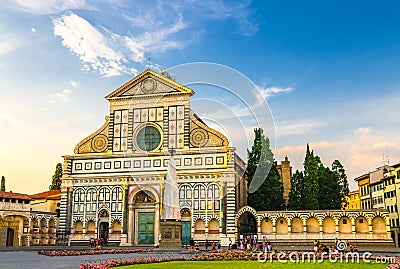 Basilica di Santa Maria Novella and green grass lawn with flowers on Piazza Santa Maria Novella square in Florence Editorial Stock Photo