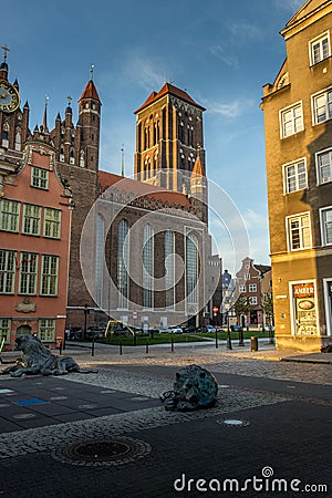 Basilica of St Mary in the old street with nearby buildings in Gdansk, Poland Editorial Stock Photo