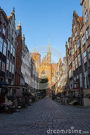 Basilica of St Mary in the old street with nearby buildings in Gdansk, Poland Editorial Stock Photo