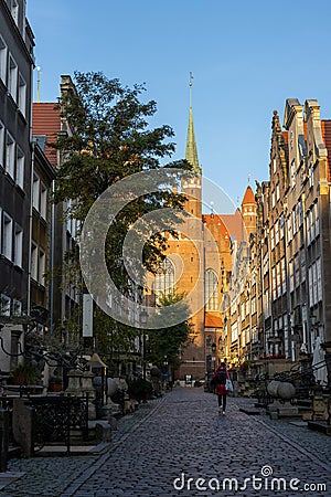 Basilica of St Mary in the old street with nearby buildings in Gdansk, Poland Editorial Stock Photo