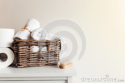 Basket with bathroom accessories. A set of rolled towels. Hotel cleaning concept Stock Photo