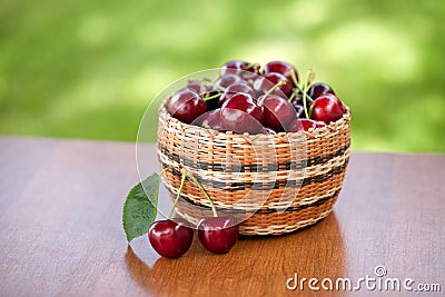 Basket of Cherries on Table Stock Photo