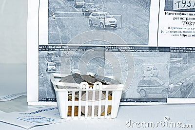 A basket of coins is a symbol of payment of a fine for a traffic violation. Russian text: identification of the state registratio Editorial Stock Photo