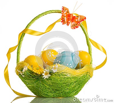 Basket with easter eggs, butterfly and ribbon on handle, isolate Stock Photo