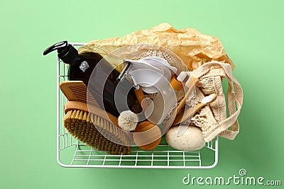 Basket with eco-friendly bath cosmetics and accessories on green background Stock Photo