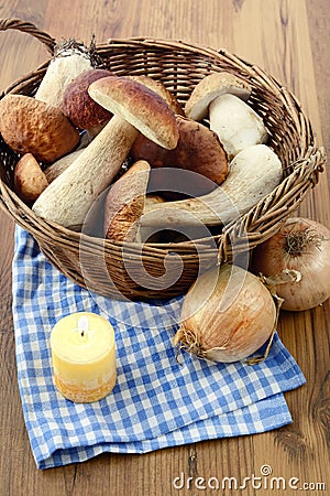 Basket with fresh penny bun mushrooms on table Stock Photo