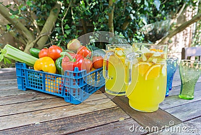 Basket of fruit with jug of orange squash. Stock Photo