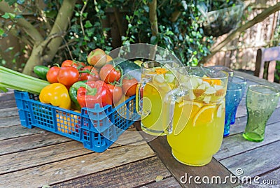 Basket of fruit with jug of orange squash. Stock Photo