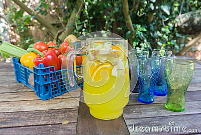 Basket of fruit with jug of orange squash. Stock Photo