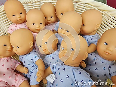 Basket full of bald baby dolls Stock Photo