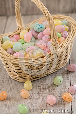 Basket full of pastel colored Easter egg candy Stock Photo