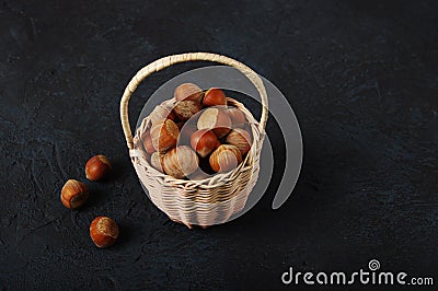 Basket Hazelnuts, filbert on wooden backdrop. heap or stack of hazelnuts. Hazelnut background Stock Photo