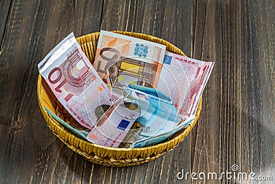 Basket with money from donations Stock Photo