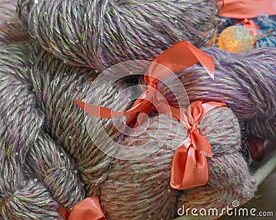 Basket with multi-colored elegant yarn, decorated with red bows. A gift for a knitter. Soft focus Stock Photo