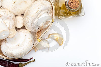 Basket of mushrooms champignon, cut feet, Agaricus Bisporus raw uncooked. With several ingredients Stock Photo