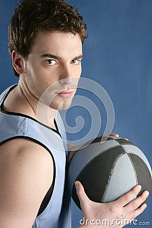 Basket player young man over blue Stock Photo