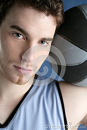 Basket player young man over blue Stock Photo