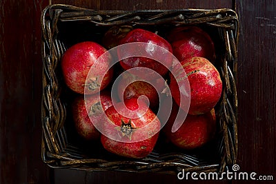 Basket of red pomegranates Stock Photo