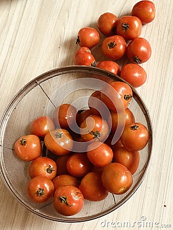 a basket of red tomatoes Stock Photo