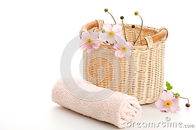 Basket, rolled towel and anemones Stock Photo