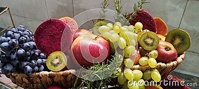 basket with varied fruits grape pear kiwi guava apple healthy food vegan detox food Stock Photo