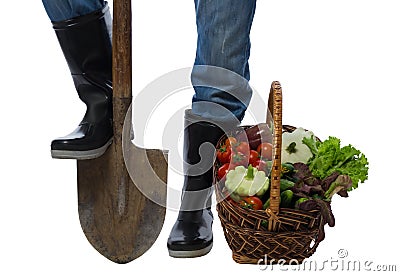 Basket of vegetables standing near a farmer's feet Stock Photo