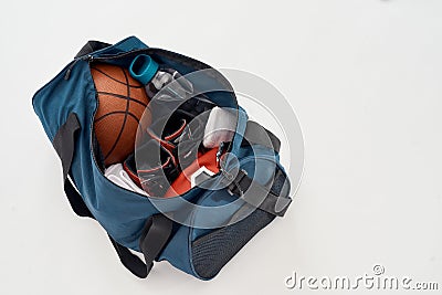 Basketball equipment. Top view of a sports bag with professional uniform, basketball ball, sneakers and bottle of water Stock Photo