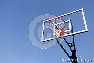 Basketball Hoop and Backboard against Blue Sky Stock Photo