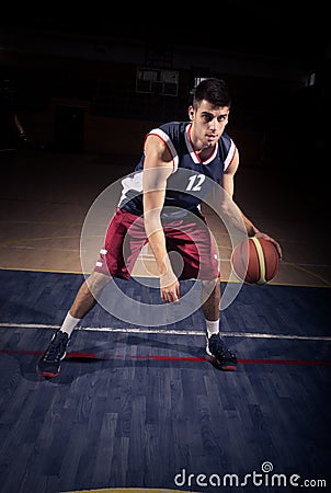 Basketball player dribble ball Stock Photo