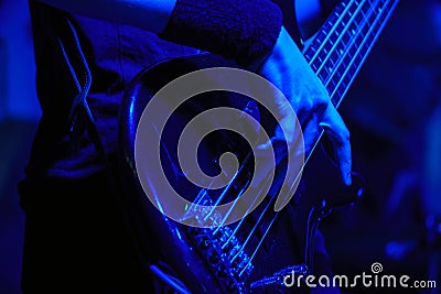 The bass guitarist plays the bass guitar Stock Photo