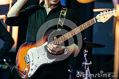 The bass guitarist plays on stage Stock Photo