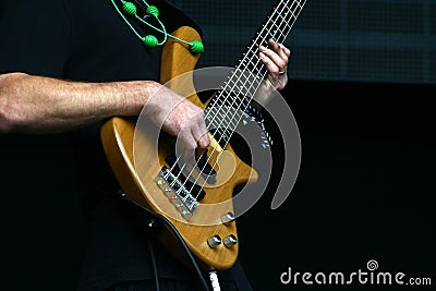 Bass player hands with five string bass guitar Stock Photo