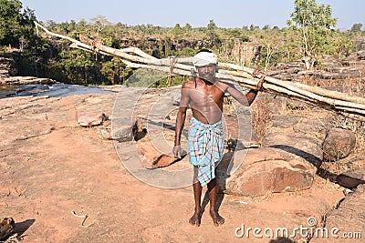 A bastar tribal man carrying woods and axe Editorial Stock Photo