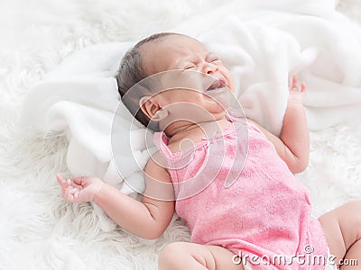 A bastard newborn baby crying in bed Because she was hungry and sick Stock Photo